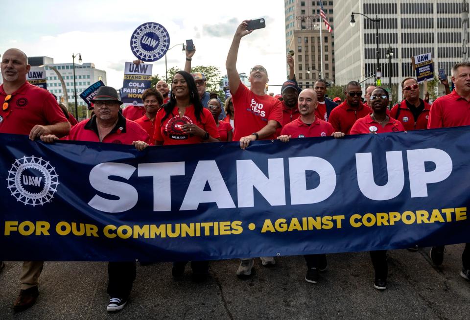 UAW President Shawn Fain walks with dozens of United Auto Workers during a rally outside the UAW-Ford Joint Trusts Center in Detroit on Sept. 15, 2023.